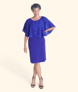 Woman posing wearing Deep Cobalt Alyssa Chiffon Burnout Cape Dress from Connected Apparel