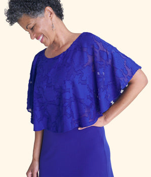 Woman posing wearing Deep Cobalt Alyssa Chiffon Burnout Cape Dress from Connected Apparel