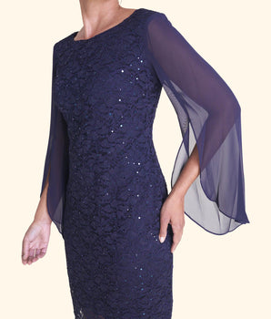 Woman posing wearing Navy Stevie Navy Sequin Lace Dress from Connected Apparel