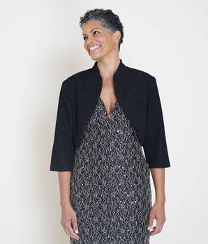 Woman posing wearing Black Adele Bolero Shrug from Connected Apparel