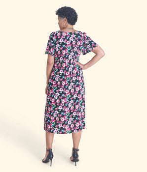 Woman posing wearing Black Adrian Floral Midi Dress from Connected Apparel