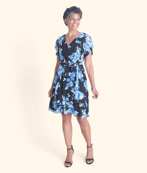 Woman posing wearing Blue Ashley Blue Floral Short Sleeve Dress from Connected Apparel