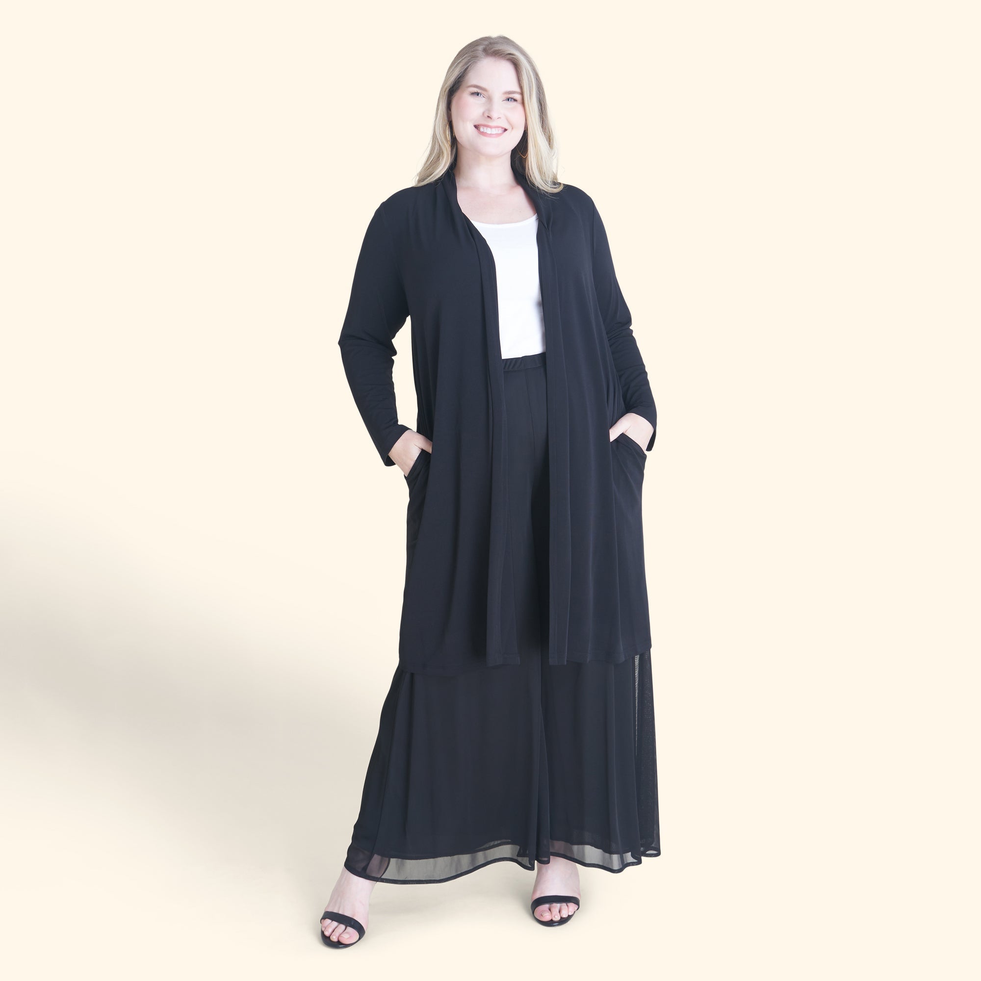 Woman posing wearing Black Bianca Black Open Front Cardigan from Connected Apparel
