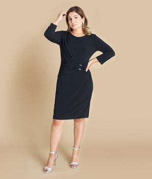 Woman posing wearing Black Cherise Little Black Long Sleeve Dress from Connected Apparel