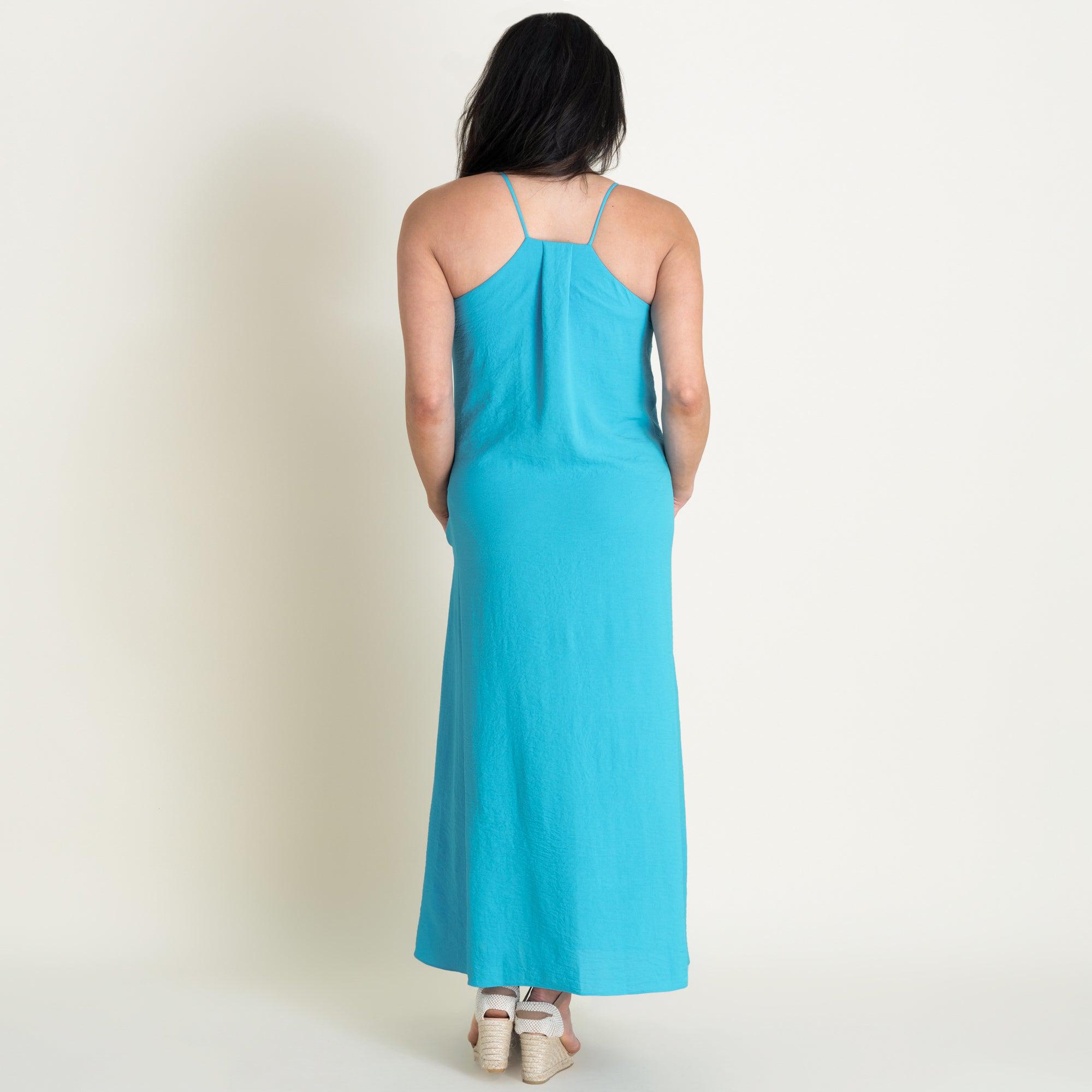 Woman posing wearing Turquoise Kelly Two-Pocket Maxi Slip Dress from Connected Apparel