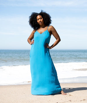 Woman posing wearing Turquoise Kelly Two-Pocket Maxi Slip Dress from Connected Apparel