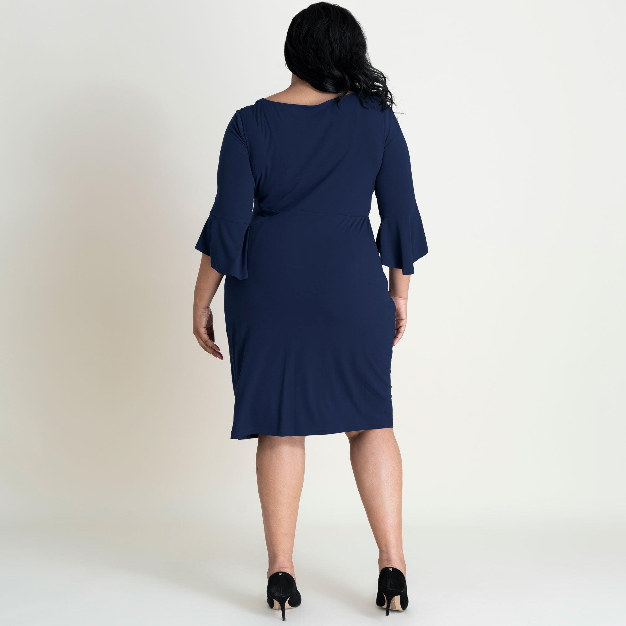 Woman posing wearing Navy Lisa 2.0 Navy Faux Wrap Dress from Connected Apparel