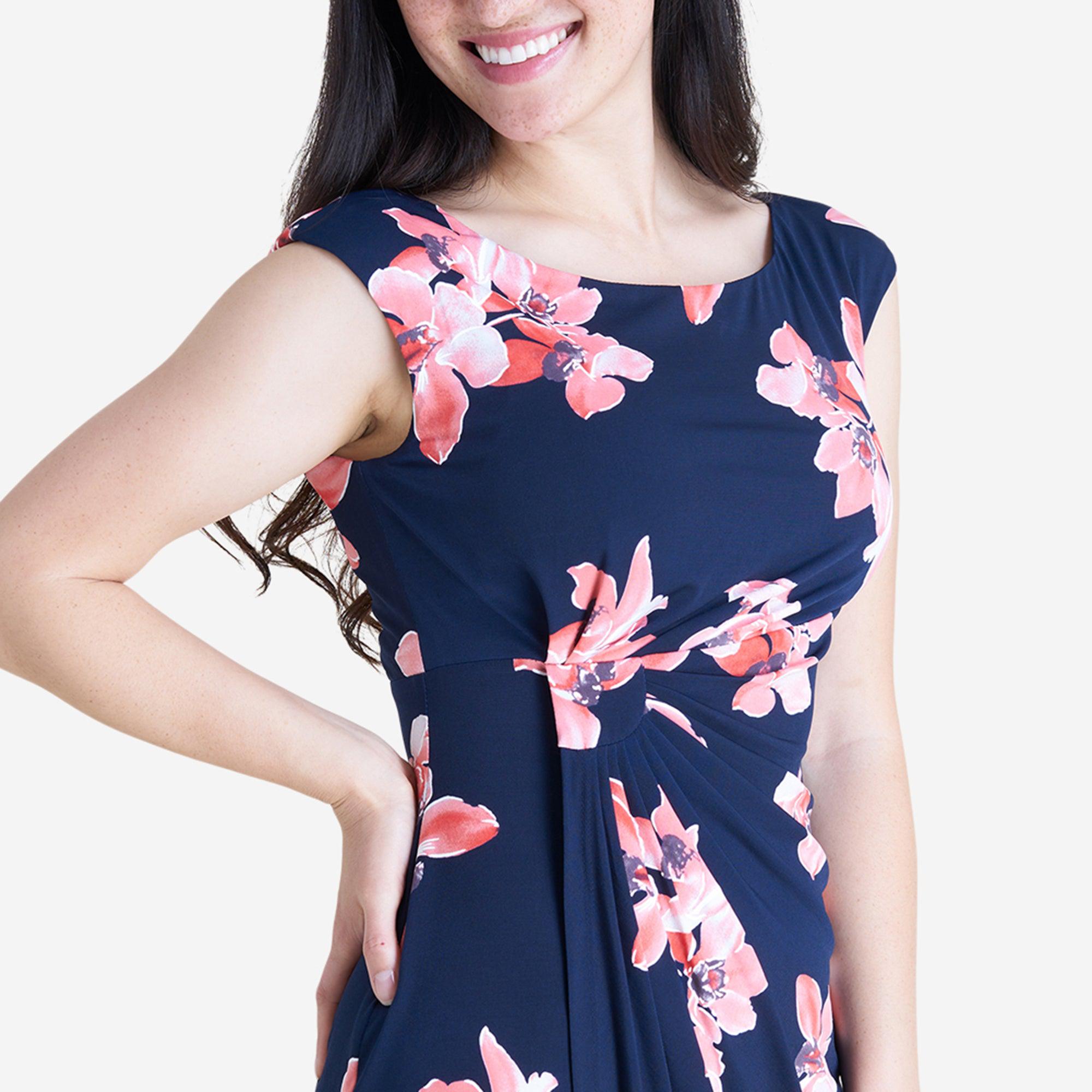 Woman posing wearing Melon Lisa Melon Floral Faux Wrap Dress from Connected Apparel