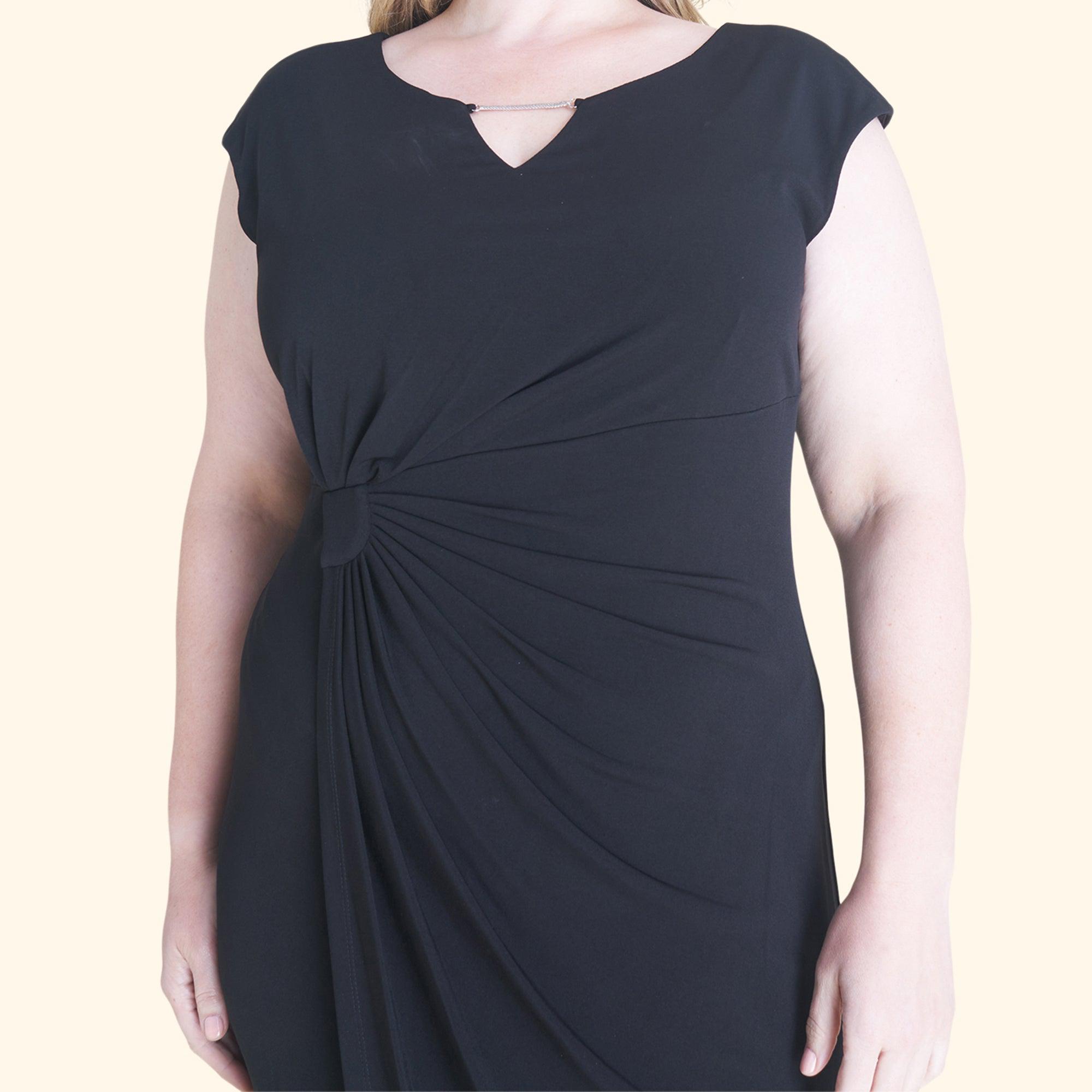 Woman posing wearing Black Lisa Sleeveless Black Faux Wrap Dress from Connected Apparel