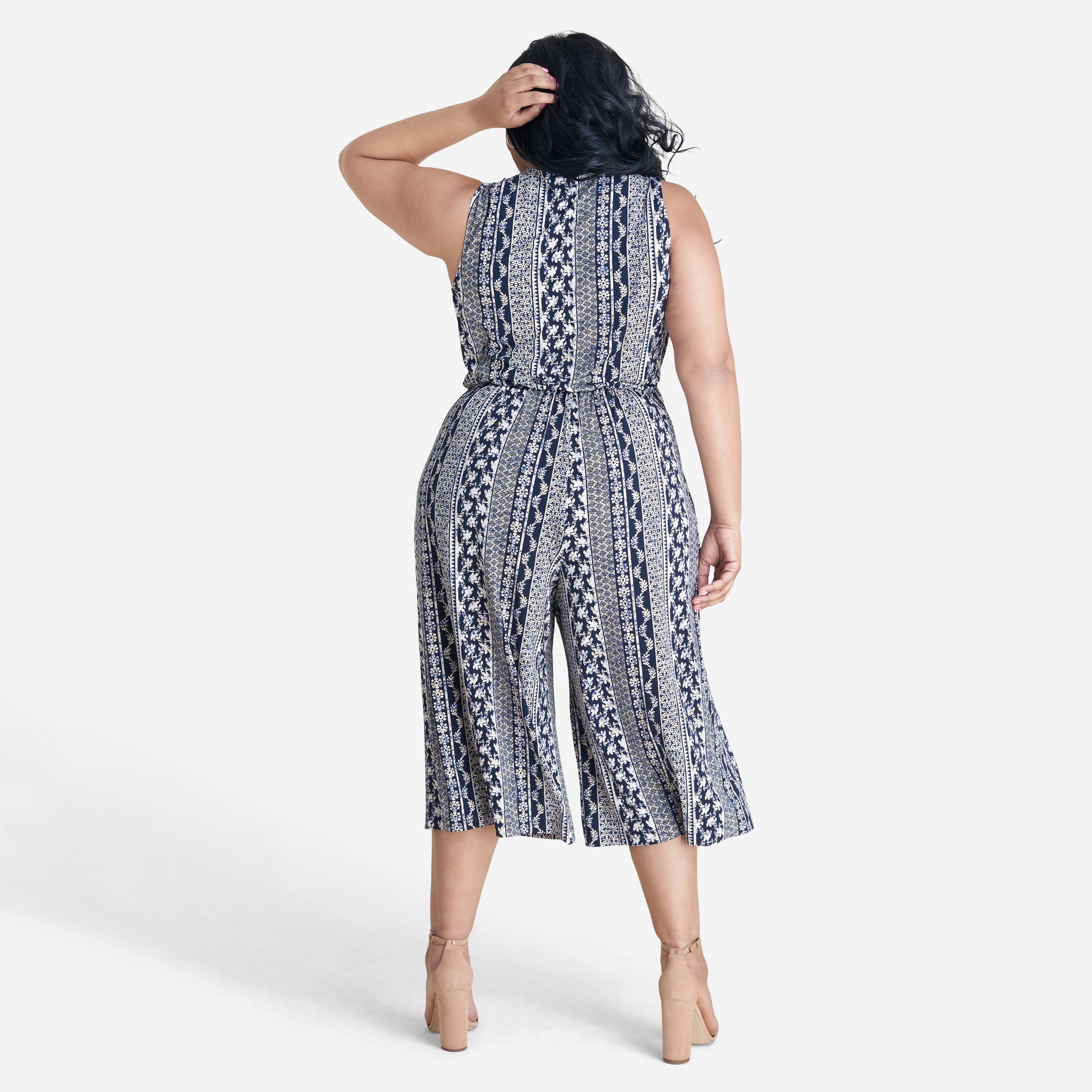 Woman posing wearing Navy/Maize Morgan Cropped Jumpsuit from Connected Apparel