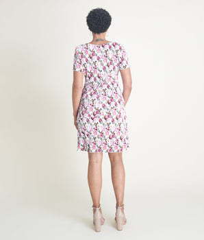 Woman posing wearing Ivory/Rose Penny Floral Bodre Sheath Dress from Connected Apparel