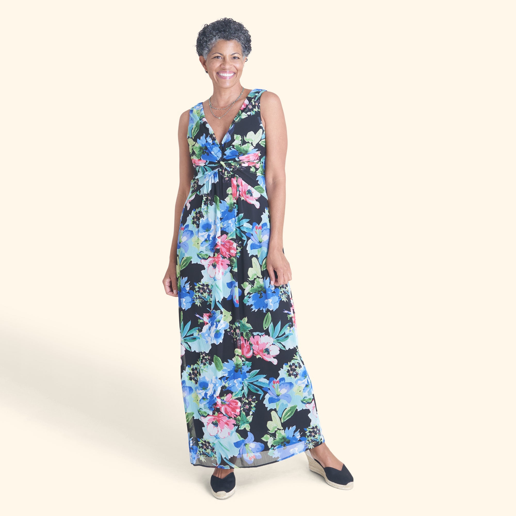 Woman posing wearing Black Reese Floral Print Maxi Dress from Connected Apparel
