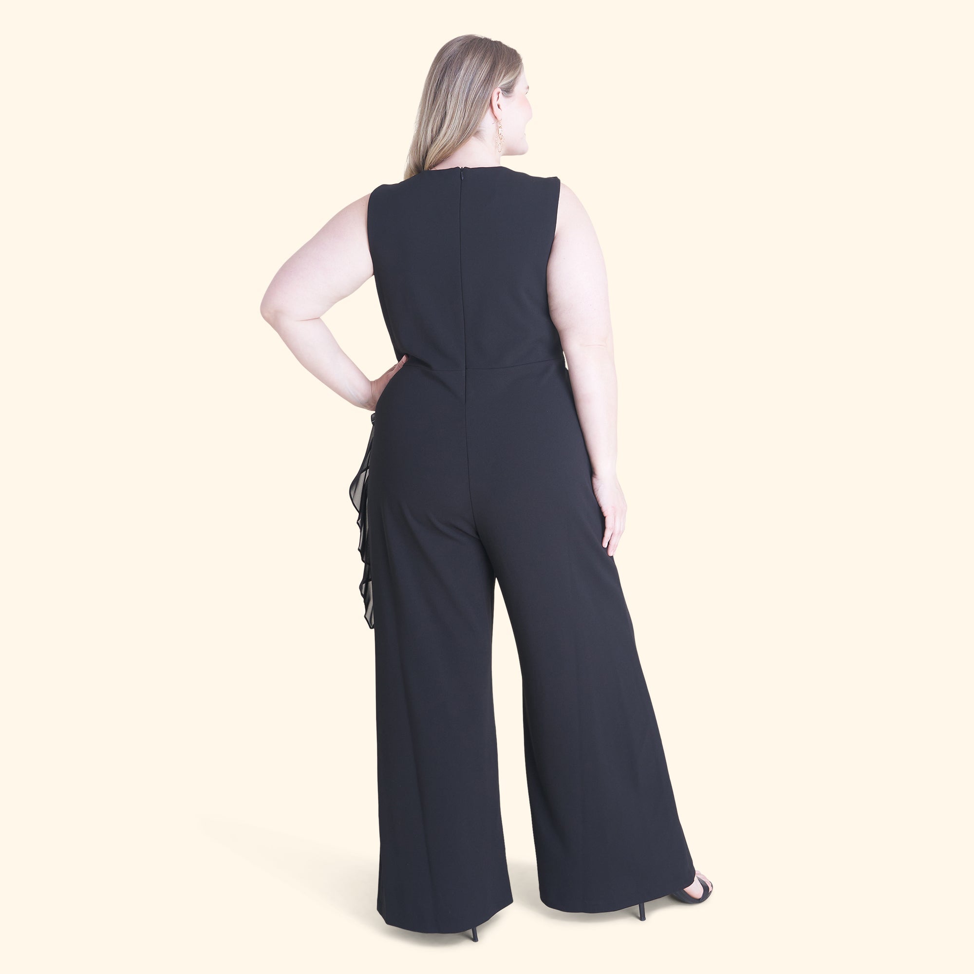 Woman posing wearing Black Sara Black Jumpsuit from Connected Apparel