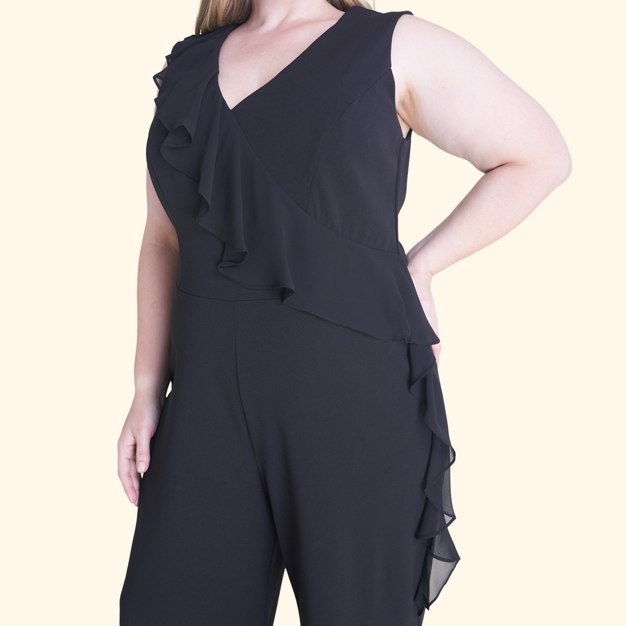 Woman posing wearing Black Sara Black Jumpsuit from Connected Apparel