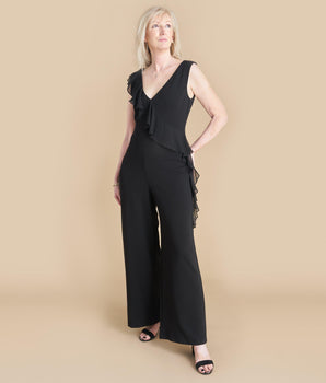 Woman posing wearing Black Sara Black Jumpsuit from Connected Apparel