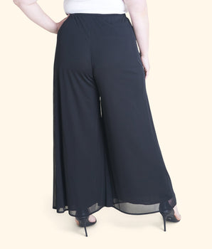 Woman posing wearing Black Sheri Black Palazzo Pant from Connected Apparel