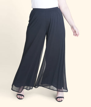 Woman posing wearing Black Sheri Black Palazzo Pant from Connected Apparel