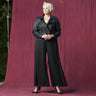 Woman posing wearing Black CAxLZ Sheri Black Palazzo Pant from Connected Apparel