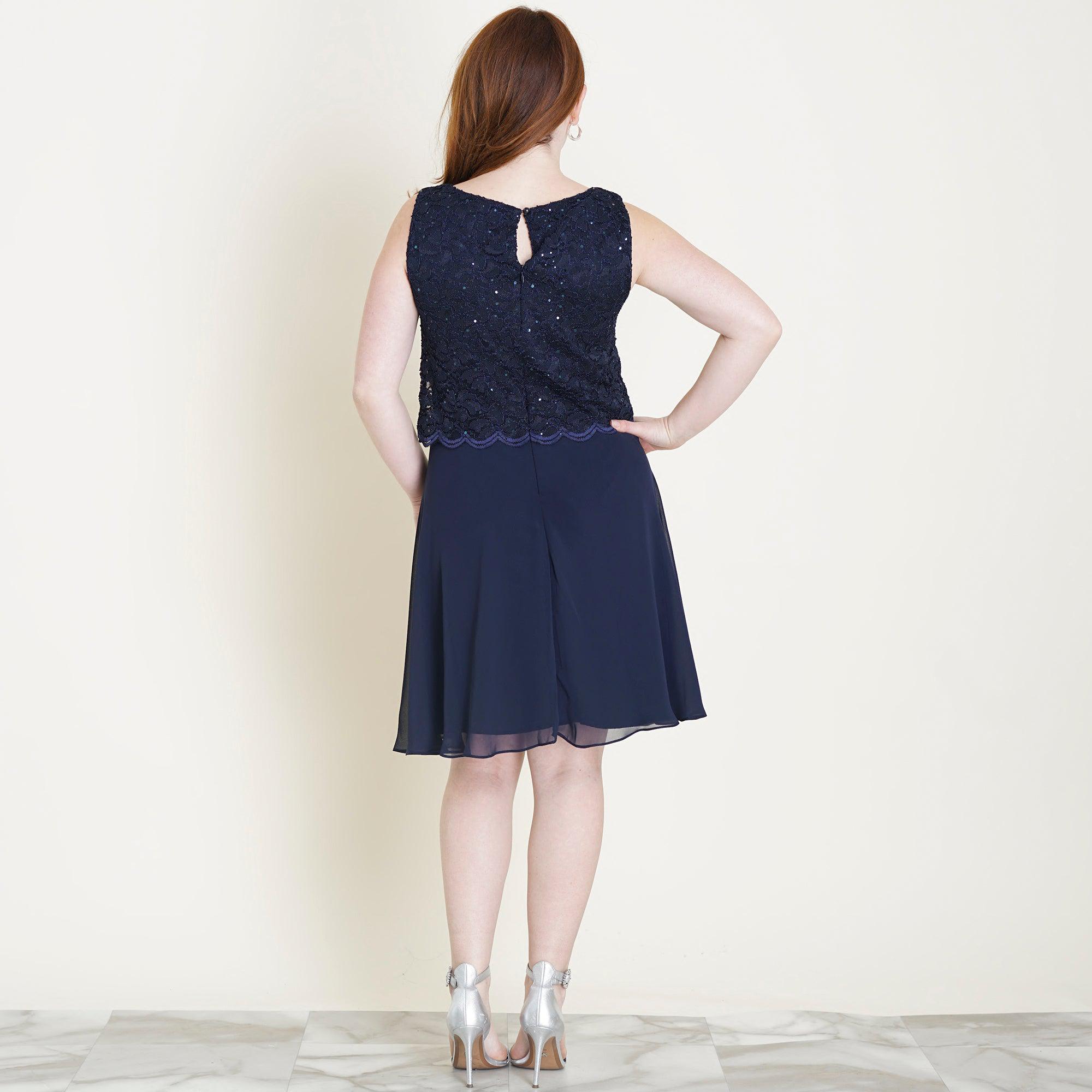 Woman posing wearing Navy Sofia Navy Sequin Lace A-Line Dress from Connected Apparel