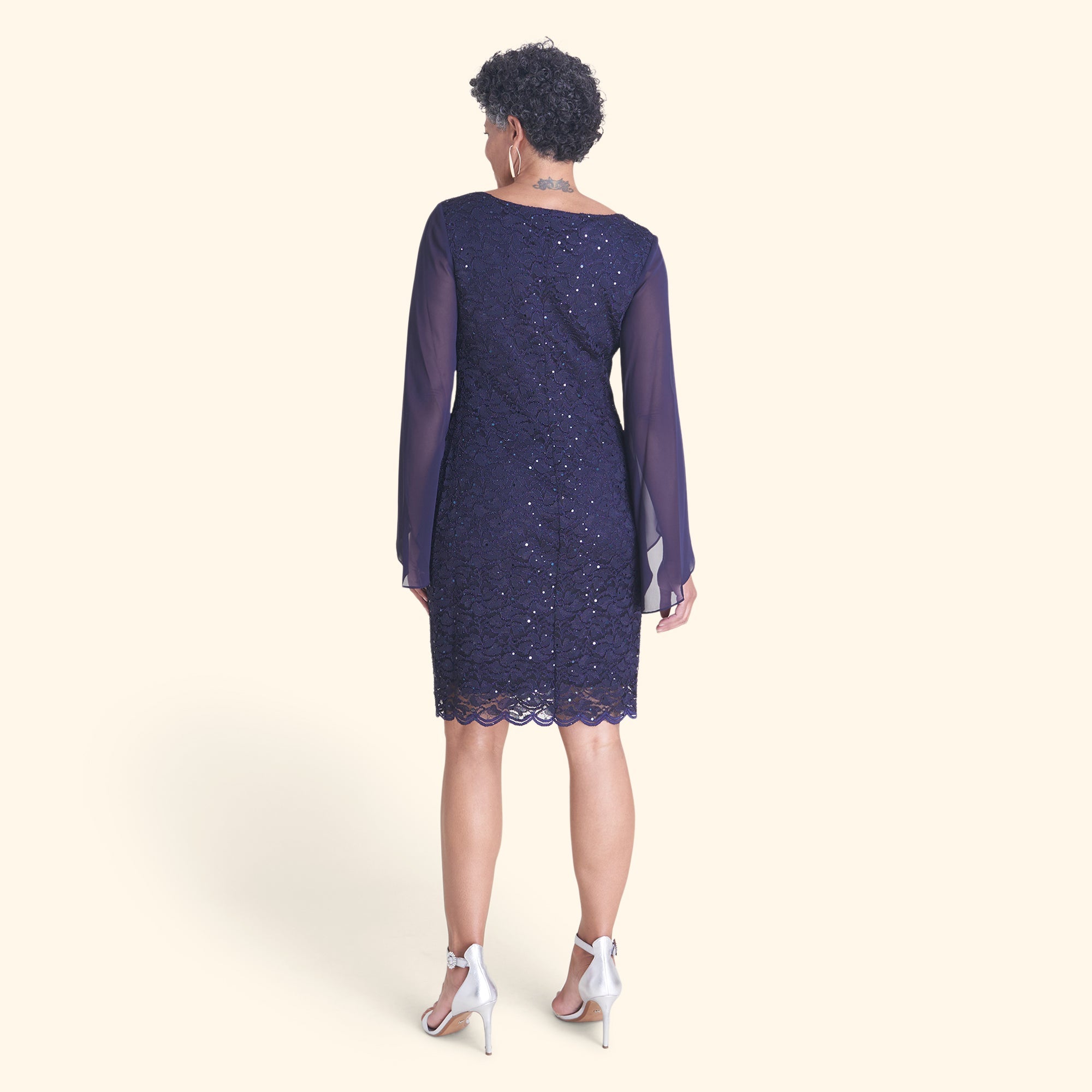 Woman posing wearing Navy Stevie Navy Sequin Lace Dress from Connected Apparel