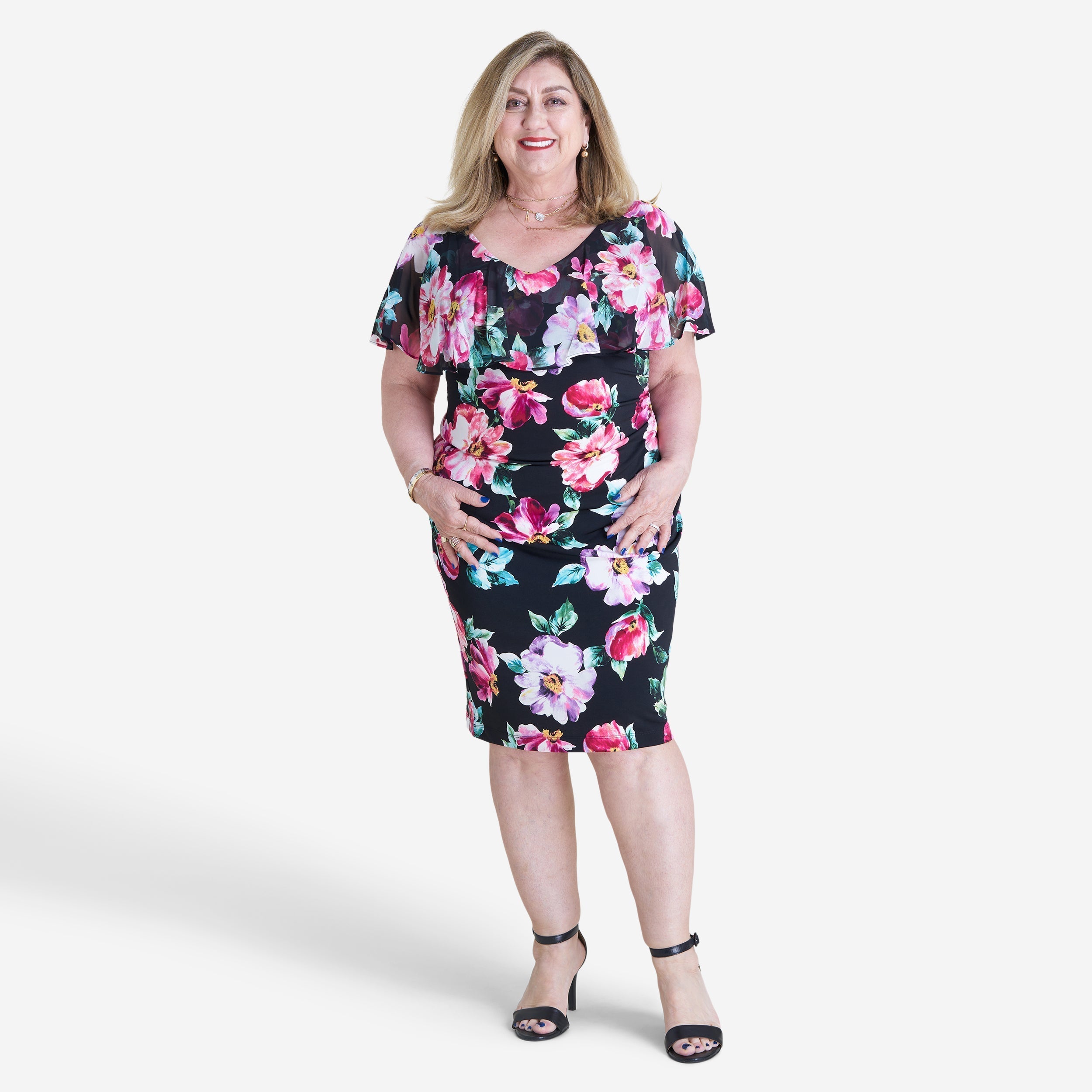 Woman posing wearing Black Sunny Floral Bodycon Dress from Connected Apparel