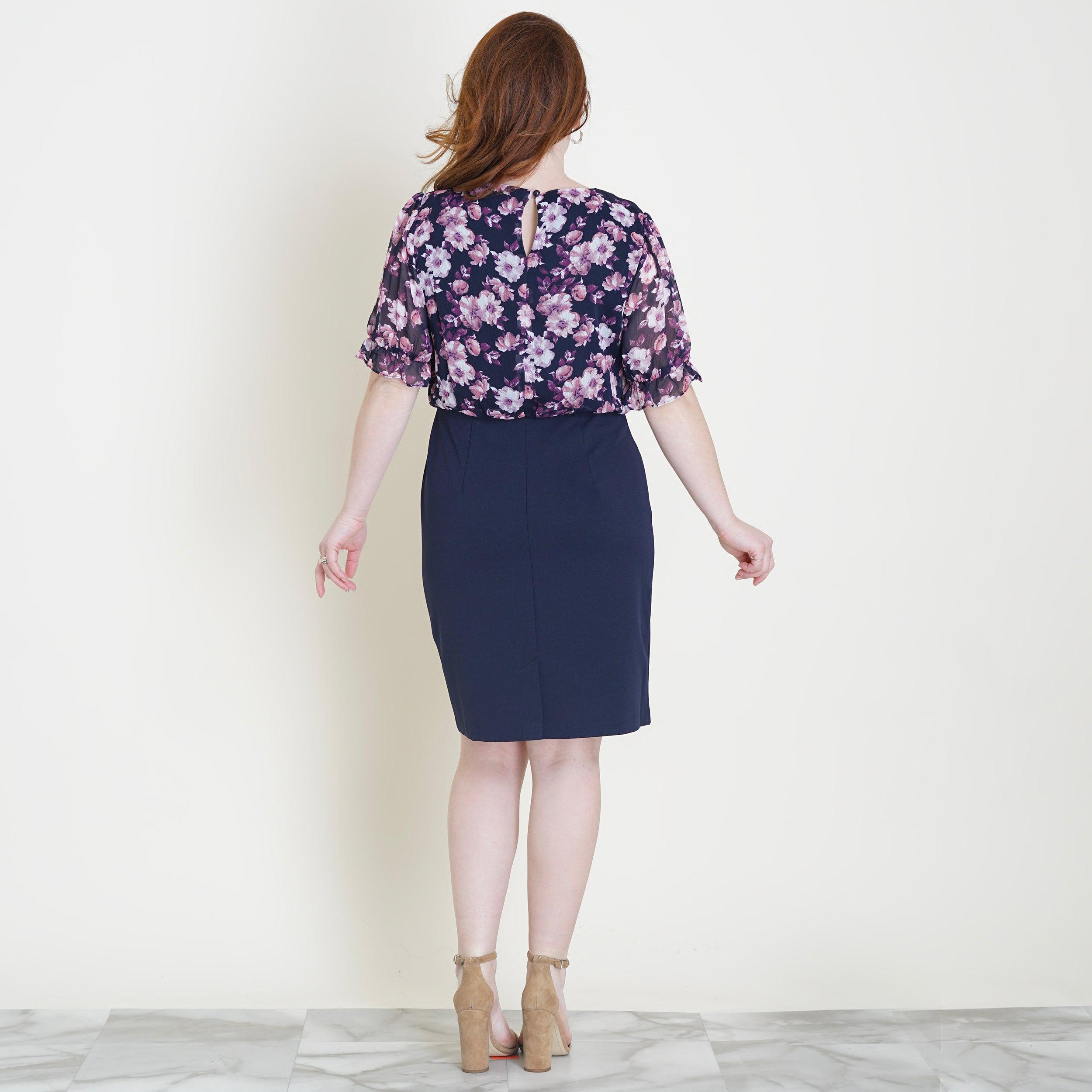 Woman posing wearing Navy/Mauve Caroline Navy and Mauve Floral Dress from Connected Apparel