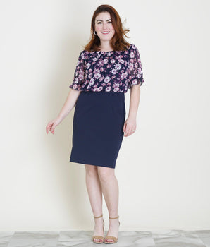 Woman posing wearing Navy/Mauve Caroline Navy and Mauve Floral Dress from Connected Apparel