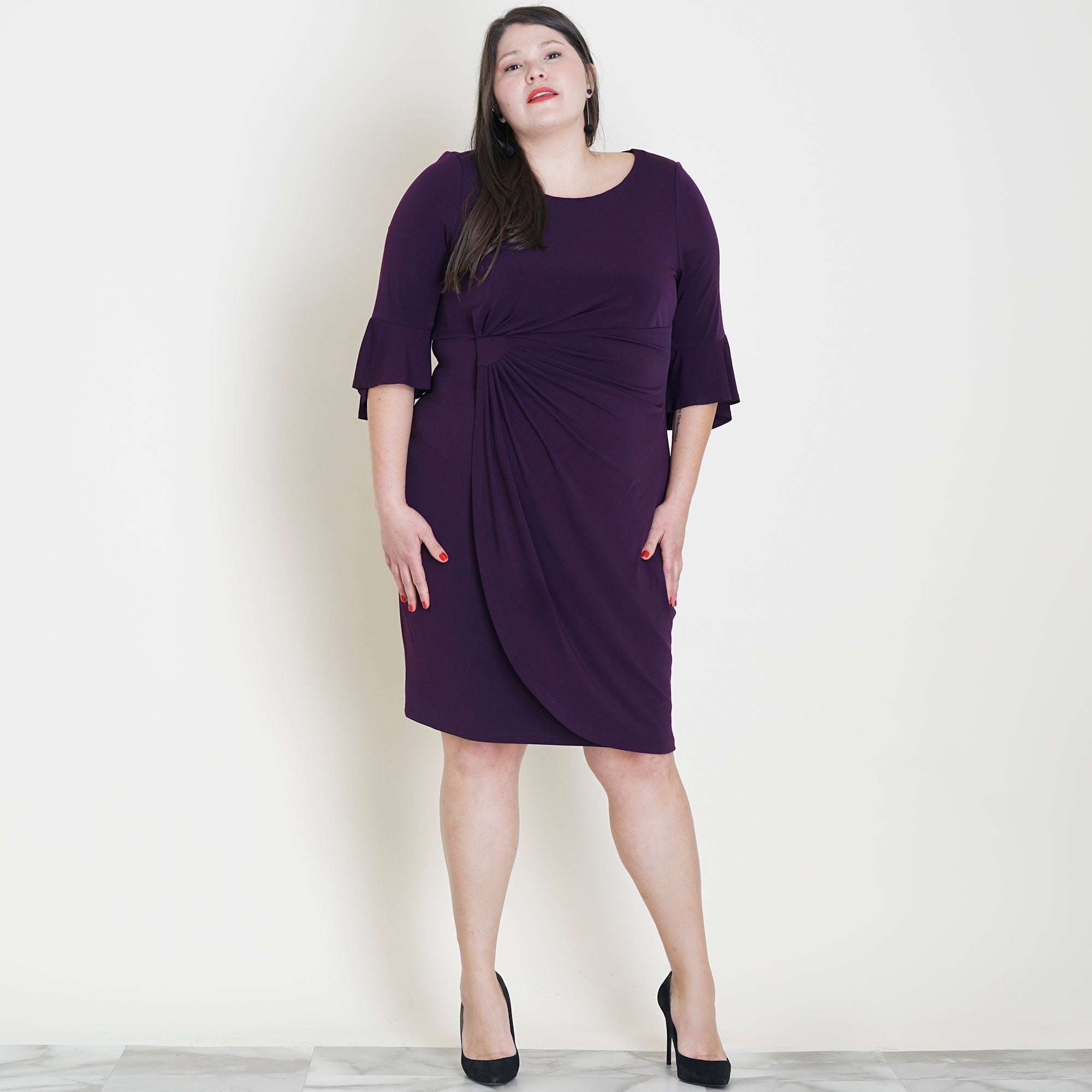 Woman posing wearing Aubergine Lisa 2.0 Aubergine Faux Wrap Dress from Connected Apparel