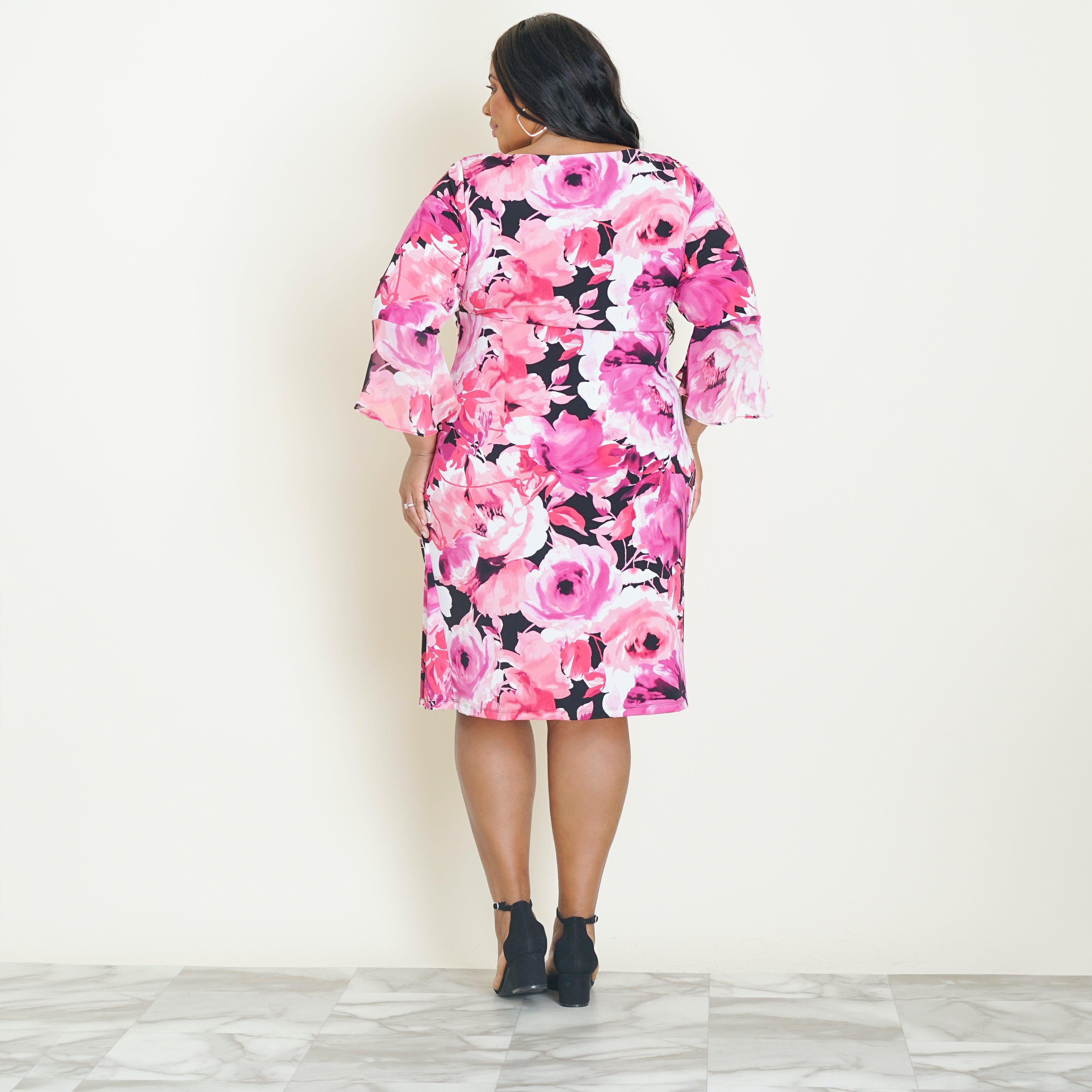 Woman posing wearing Carnation Lisa 2.0 Carnation Floral Faux Wrap Dress from Connected Apparel