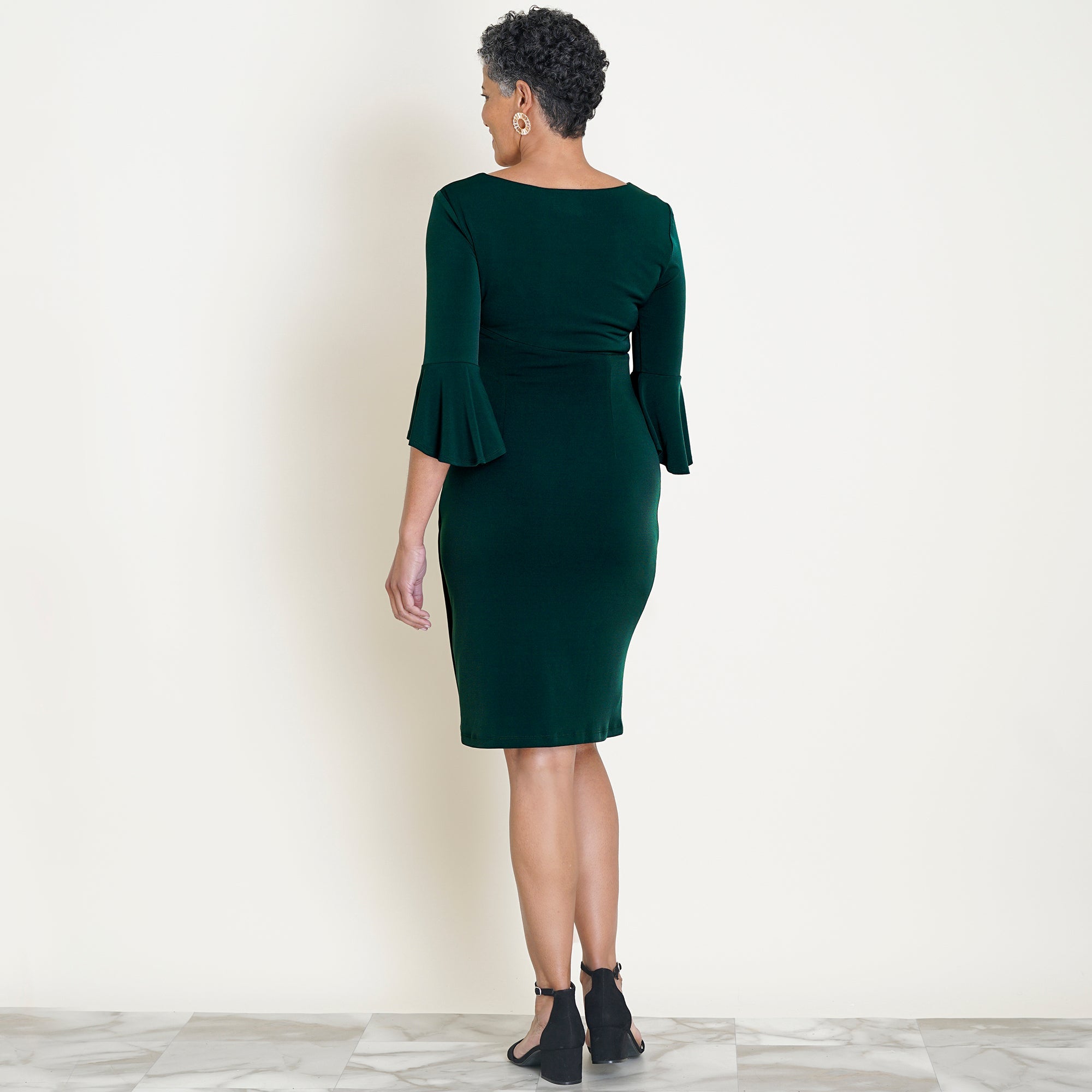 Woman posing wearing Hunter Lisa 2.0 Hunter Green Faux Wrap Dress from Connected Apparel