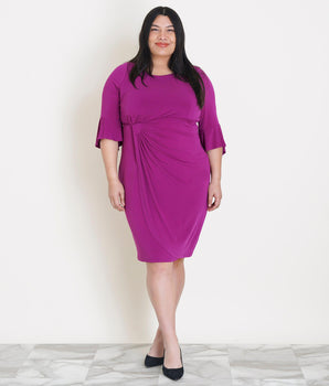 Woman posing wearing Magenta Lisa 2.0 Magenta Faux Wrap Dress from Connected Apparel