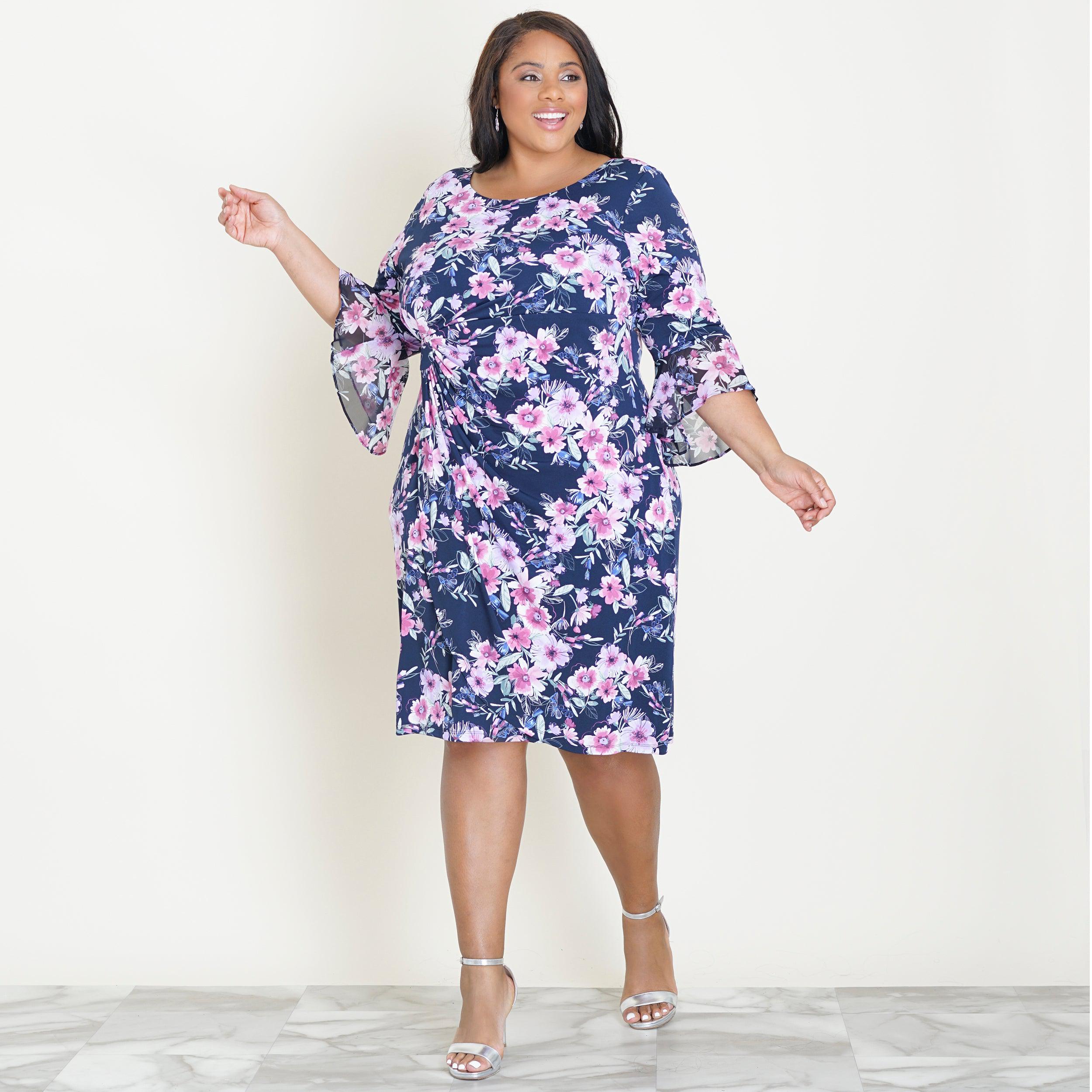 Woman posing wearing Navy/Mauve Lisa 2.0 Navy and Mauve Floral Faux Wrap Dress from Connected Apparel