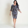 Woman posing wearing Brown Lisa 2.0 Paisley Print Faux Wrap Dress from Connected Apparel