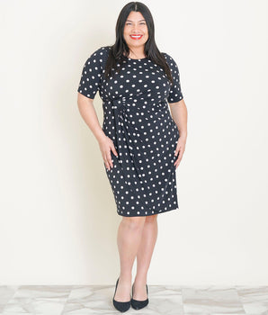 Woman posing wearing Black/White Lisa Black and White Polka Dot Faux Wrap Dress from Connected Apparel