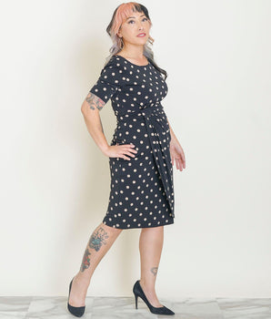 Woman posing wearing Camel Lisa Camel Polka Dot Faux Wrap Dress from Connected Apparel