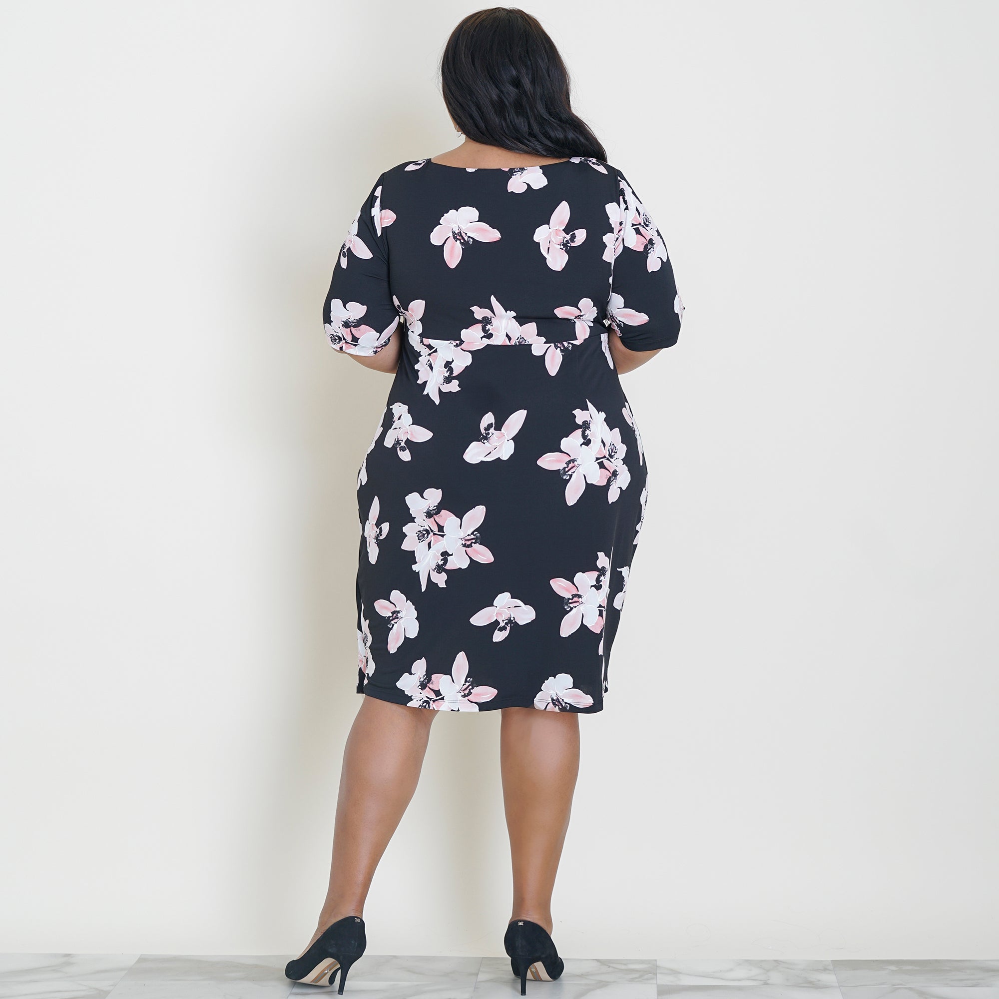 Woman posing wearing Cameo Lisa Cameo Floral Elbow Sleeve Dress from Connected Apparel
