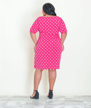 Woman posing wearing New Fuchsia Lisa Fuchsia Polka Dot Faux Wrap Dress from Connected Apparel