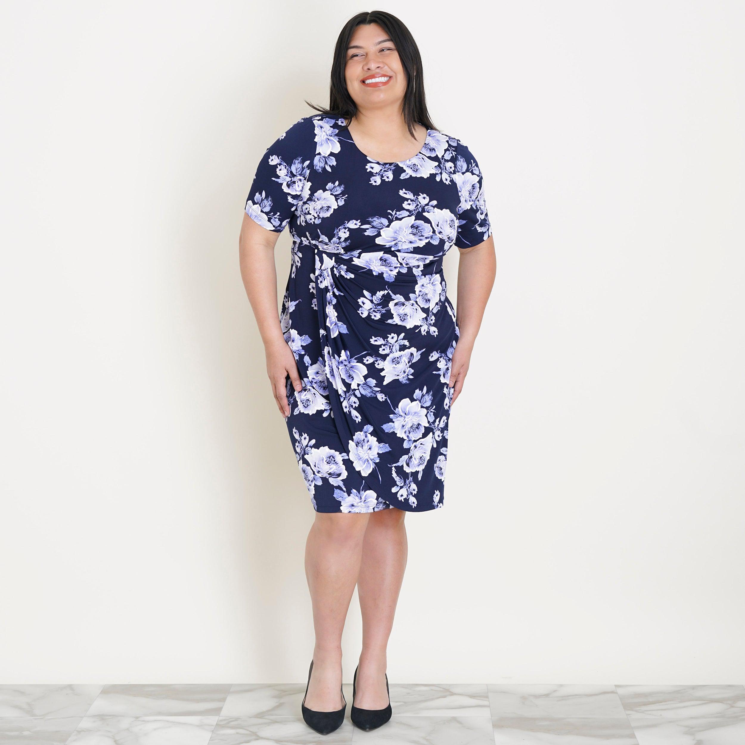Woman posing wearing Periwinkle Lisa Periwinkle Floral Faux Wrap Dress from Connected Apparel