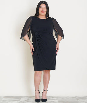 Woman posing wearing Black Lisette Chiffon Sleeve Little Black Dress from Connected Apparel