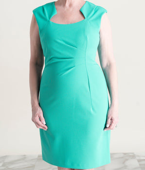 Woman posing wearing Sea Green Mona Sea Green Sheath Dress from Connected Apparel
