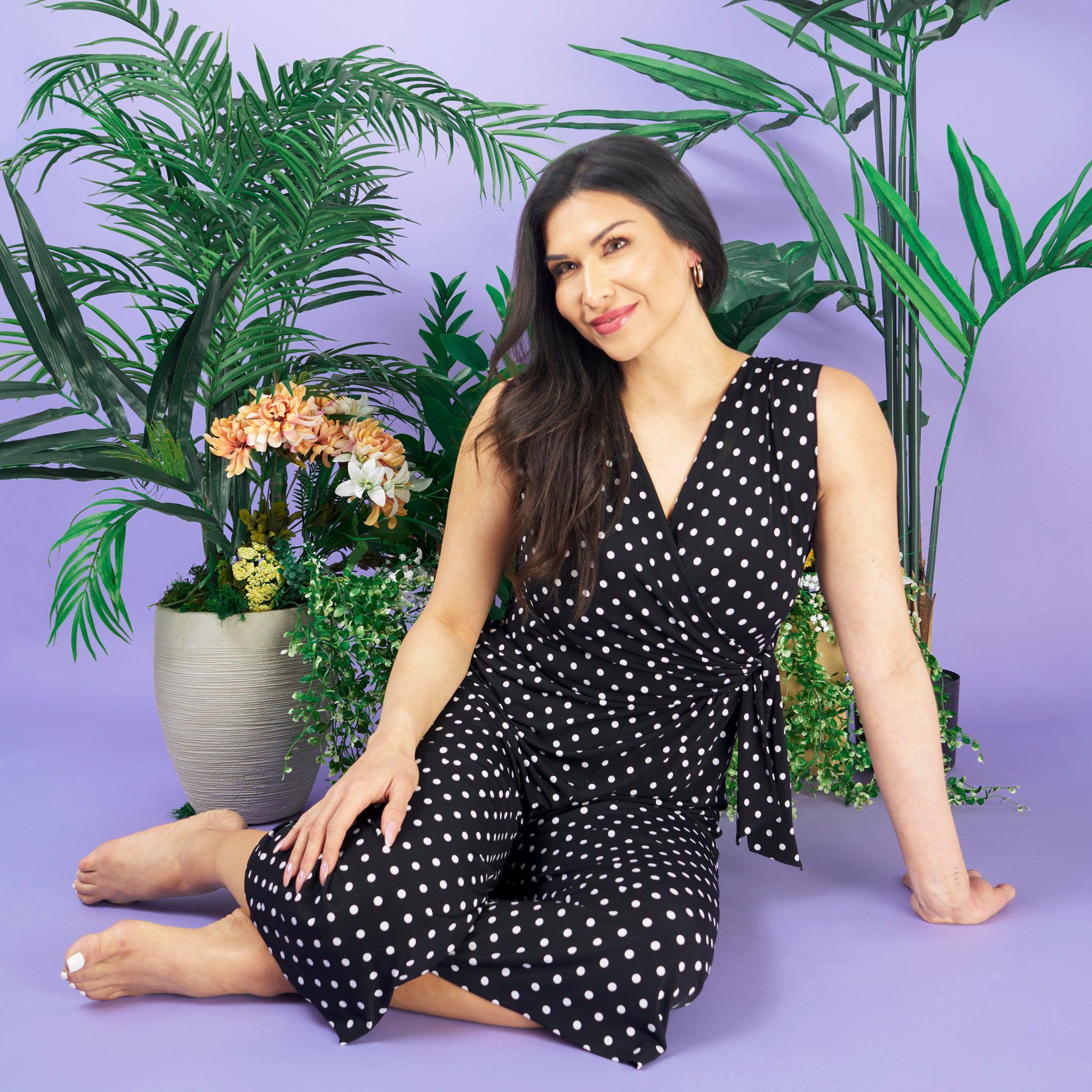 Woman posing wearing Black Morgan Black and White Polka Dot Jumpsuit from Connected Apparel