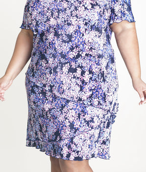 Woman posing wearing Periwinkle Penny Periwinkle Floral Sheath Dress from Connected Apparel