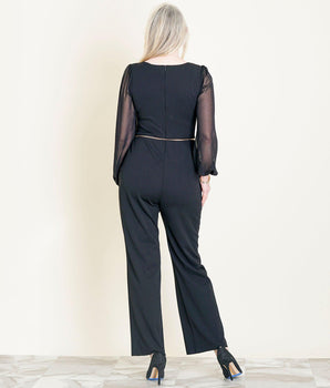 Woman posing wearing Black Sheryl Long Sleeve Black Jumpsuit from Connected Apparel