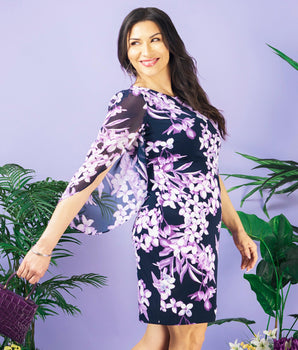 Woman posing wearing Navy/Lavender Stevie Navy and Lavender Floral Sheath Dress from Connected Apparel