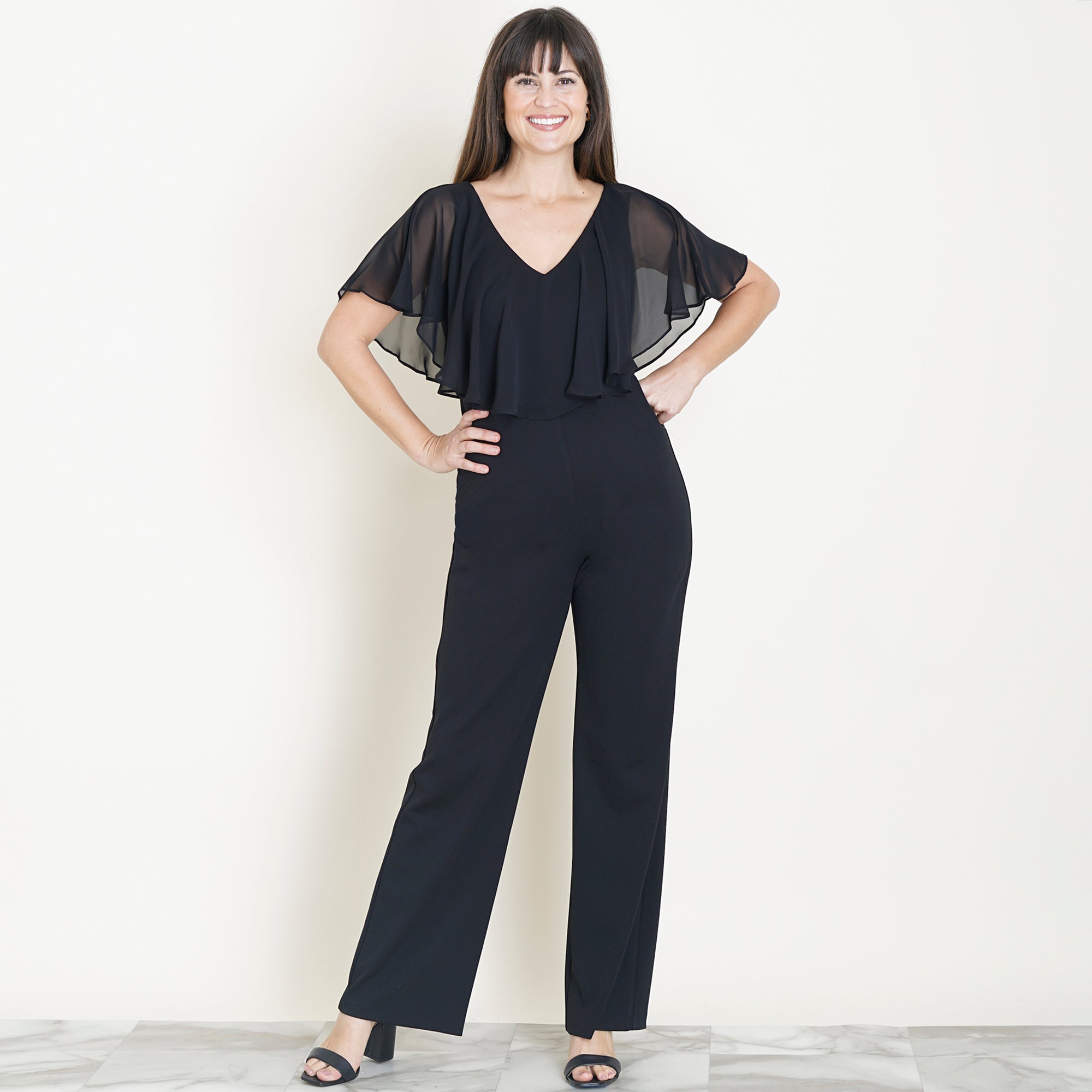 Woman posing wearing Black Sunny 2.0 Jumpsuit from Connected Apparel