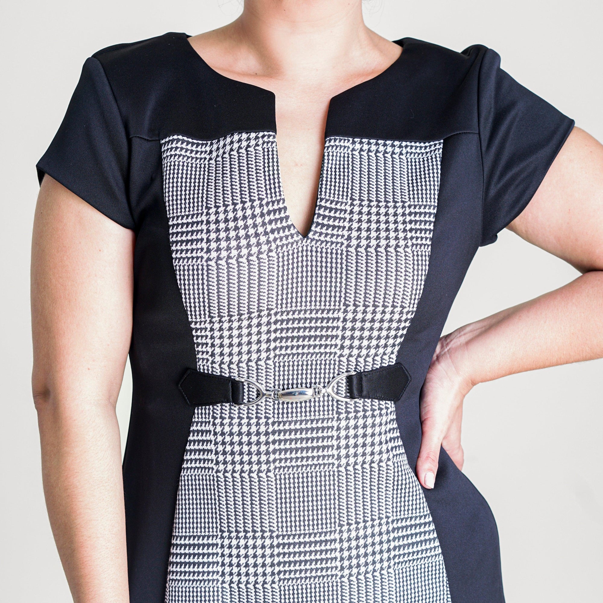 Woman posing wearing Black Tori Plaid Center Panel Work Dress from Connected Apparel