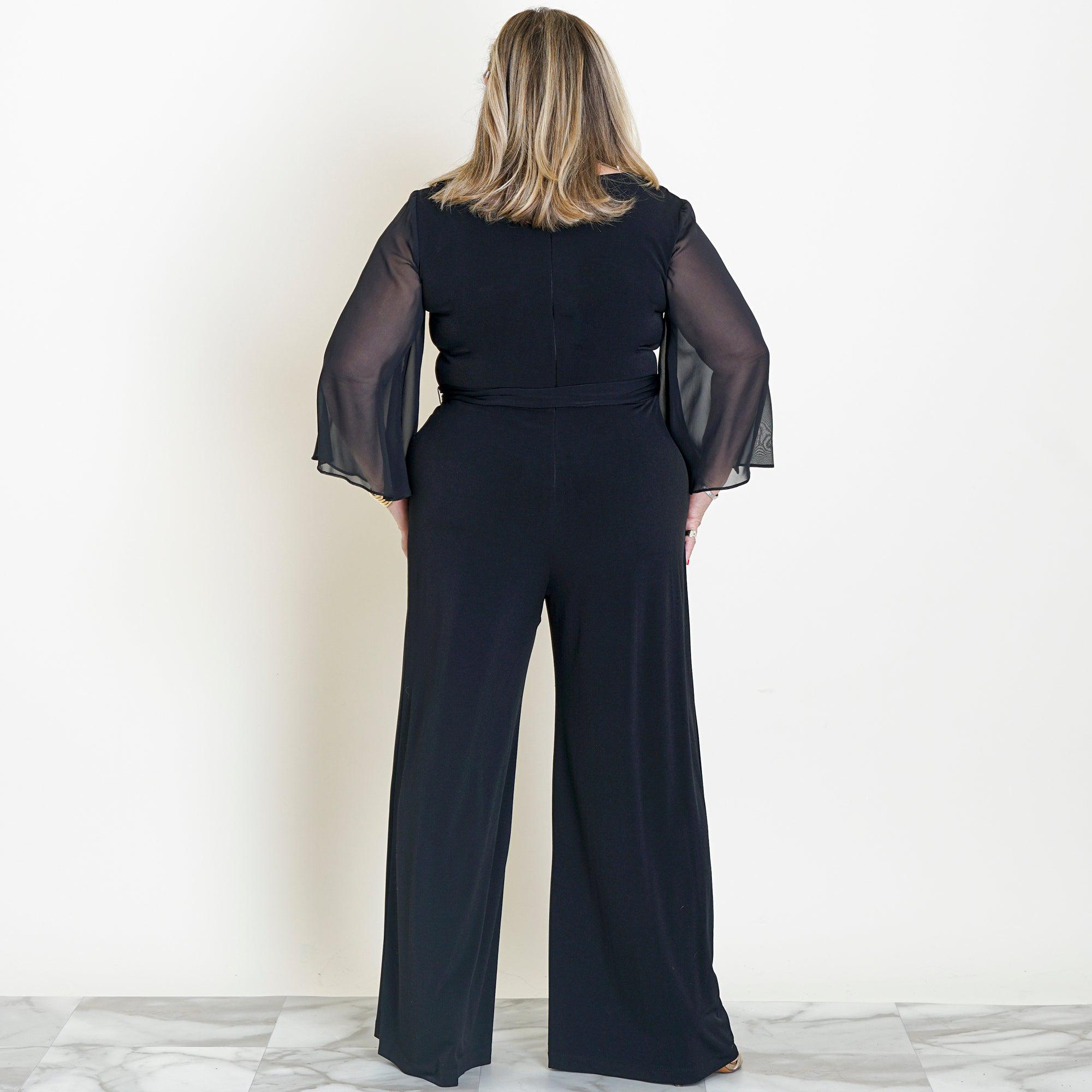 Woman posing wearing Black Uptown 2.0 Black Jumpsuit from Connected Apparel