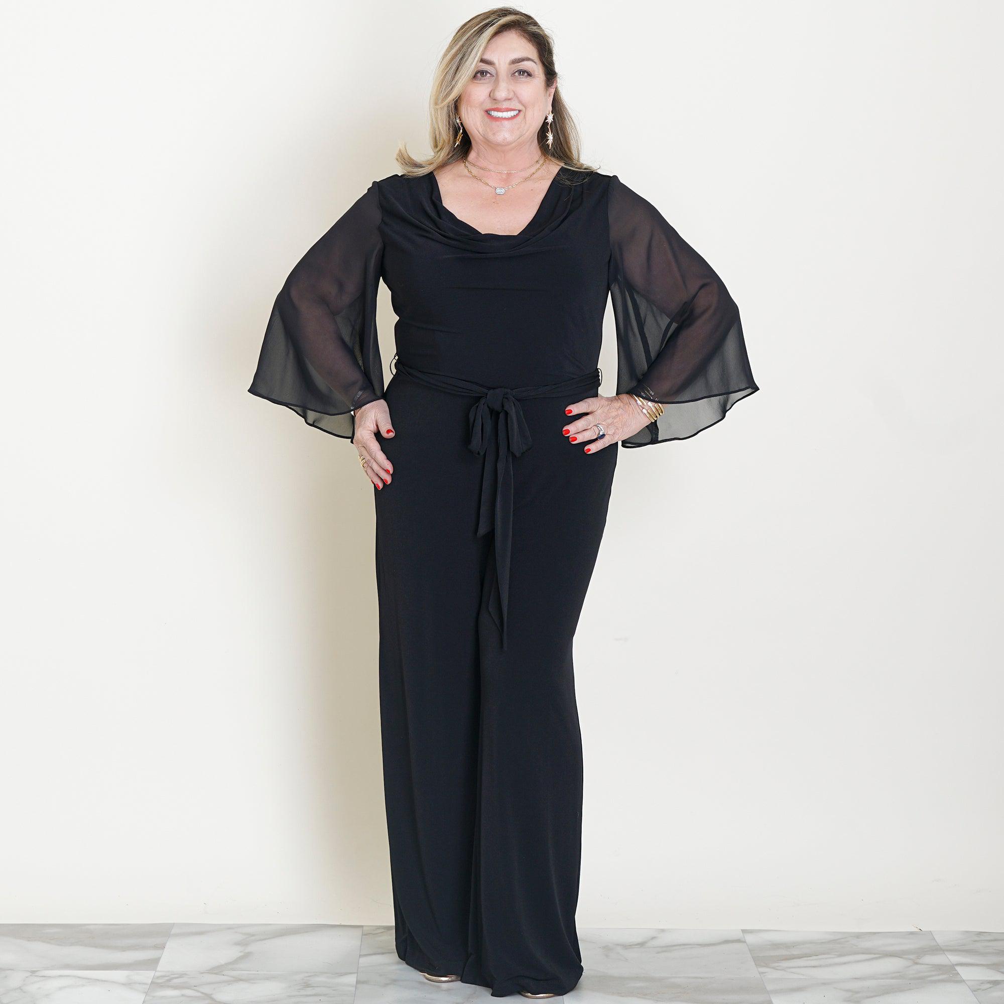 Woman posing wearing Black Uptown 2.0 Black Jumpsuit from Connected Apparel