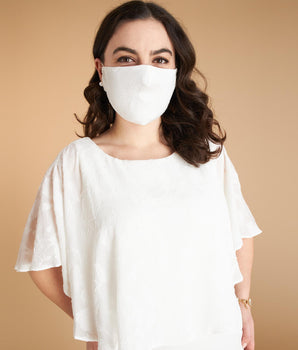 Woman posing wearing White White Burnout Chiffon Face Mask from Connected Apparel